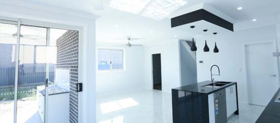 Open white living and dining with pendant lighting